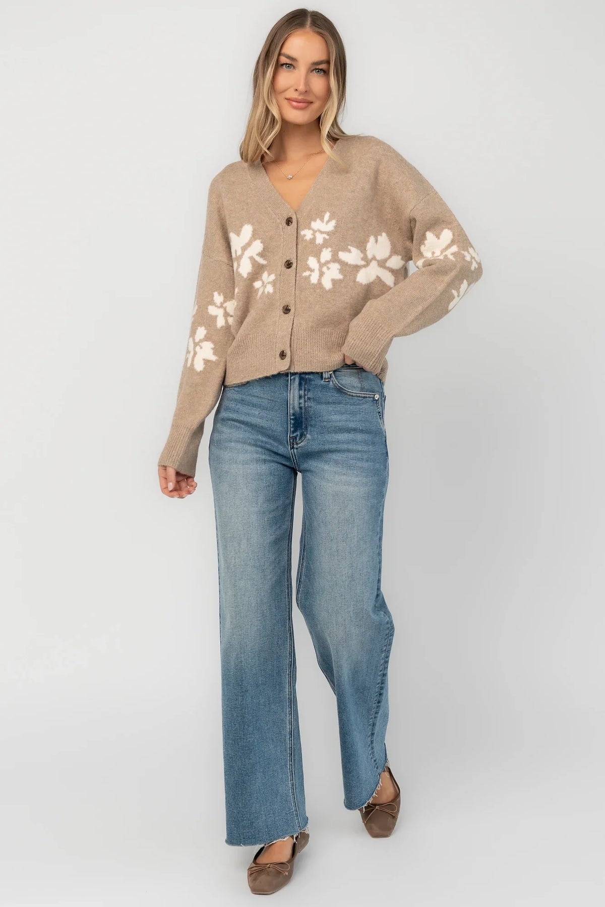 Taupe floral knit cardigan with a V-neckline, button-front closure, long sleeves, ribbed trim, and a relaxed silhouette.